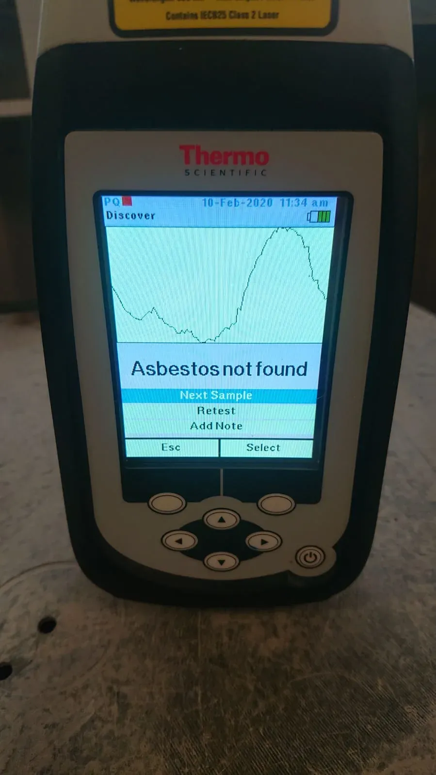 Thermo microPHAZIR analyzer displaying an on-site asbestos test result — Asbestos Watch
