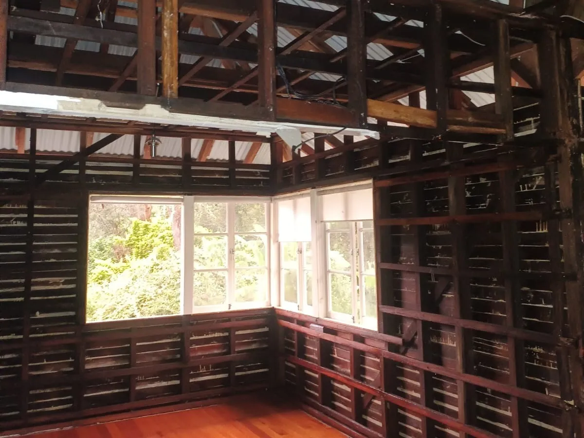Interior soft-stripped back to its timber frame — wall and ceiling linings removed, structure left intact